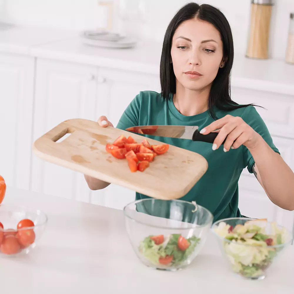 A woman preparing food in a kitchen