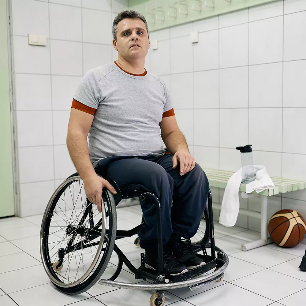 A disabled man in a sports facility change room